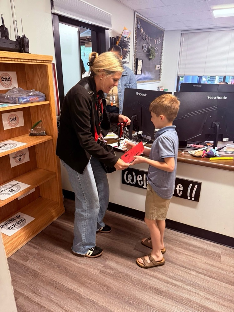 Student earned a medal for earning 500 bones for great behavior.