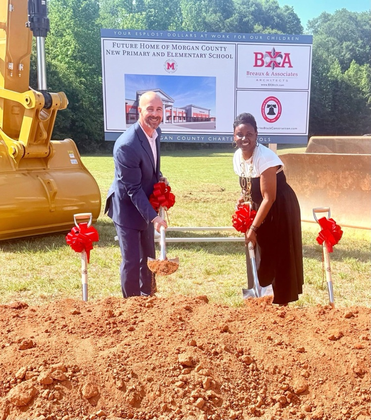 Dr. Cooper and Mrs. Chapman scoop dirt at the groundbreaking ceremony for the new MCPS and MCES  