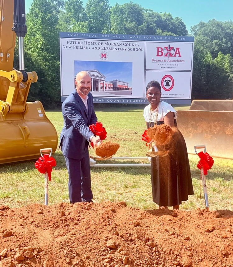 Dr. Cooper and Mrs. Chapman scoop dirt at the groundbreaking ceremony for the new MCPS and MCES. 