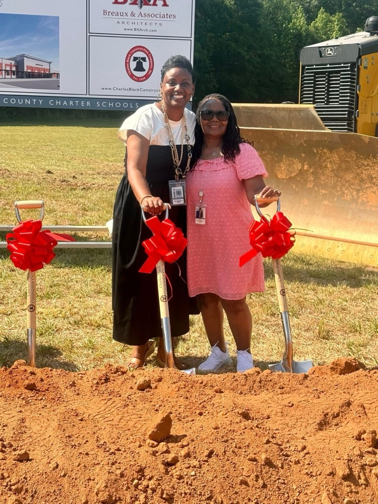 Mrs. Chapman and Mrs. Charlotte Mack pose at the groundbreaking ceremony for the new school  