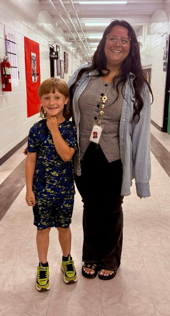 Kindergarten student with teacher who received a bike for the most growth in reading test scores. 