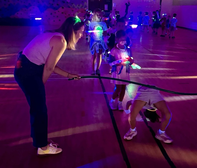 Glow party for students who raised $500 for fun run.