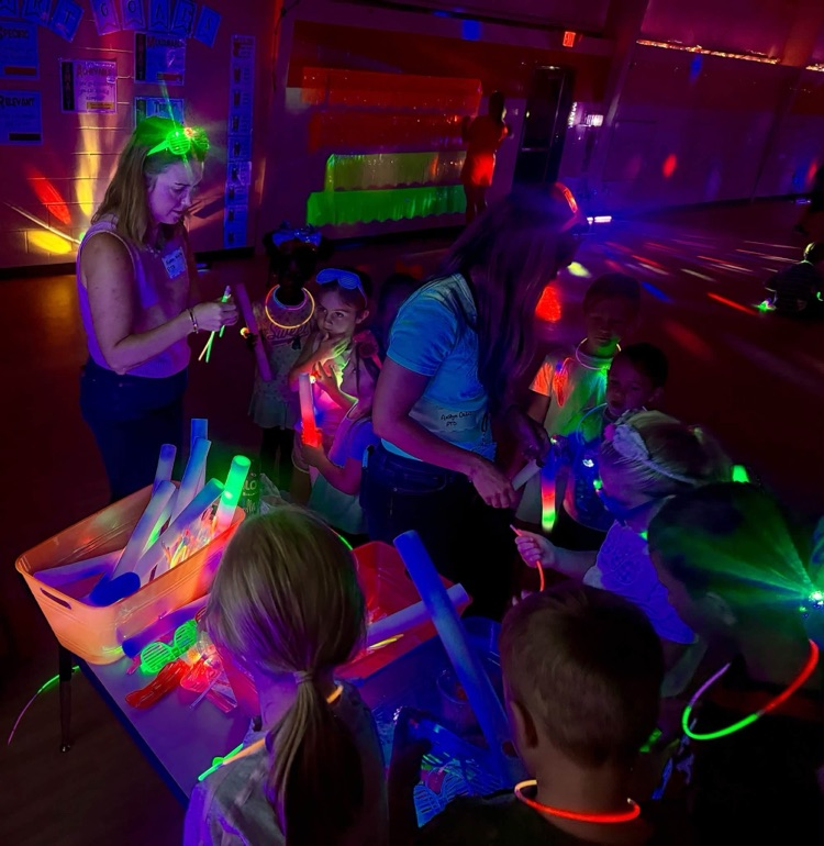 Glow party for students who raised $500 for fun run.
