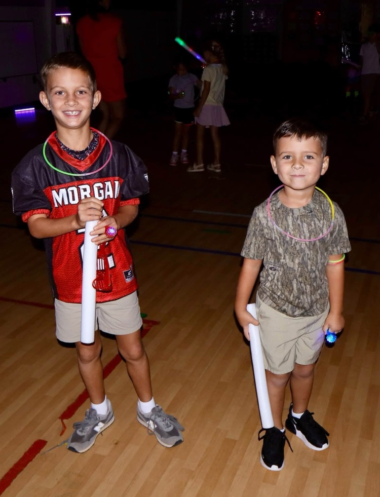 Glow party for students who raised $500 for fun run.
