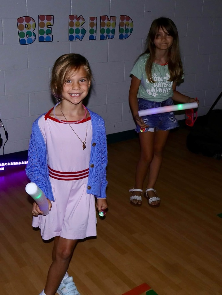 Glow party for students who raised $500 for fun run.
