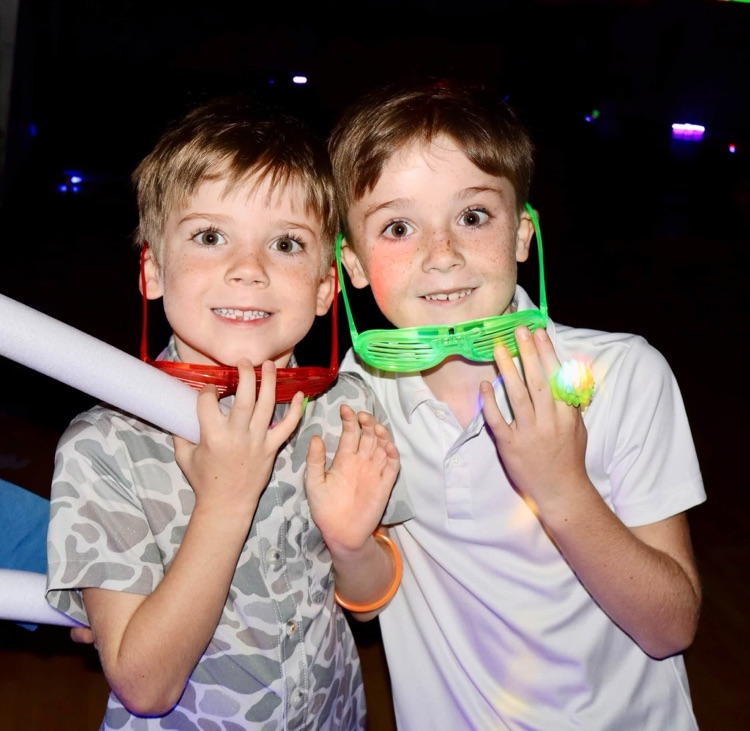 Glow party for students who raised $500 for fun run.