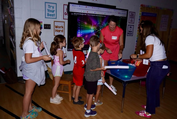 Glow party for students who raised $500 for fun run.