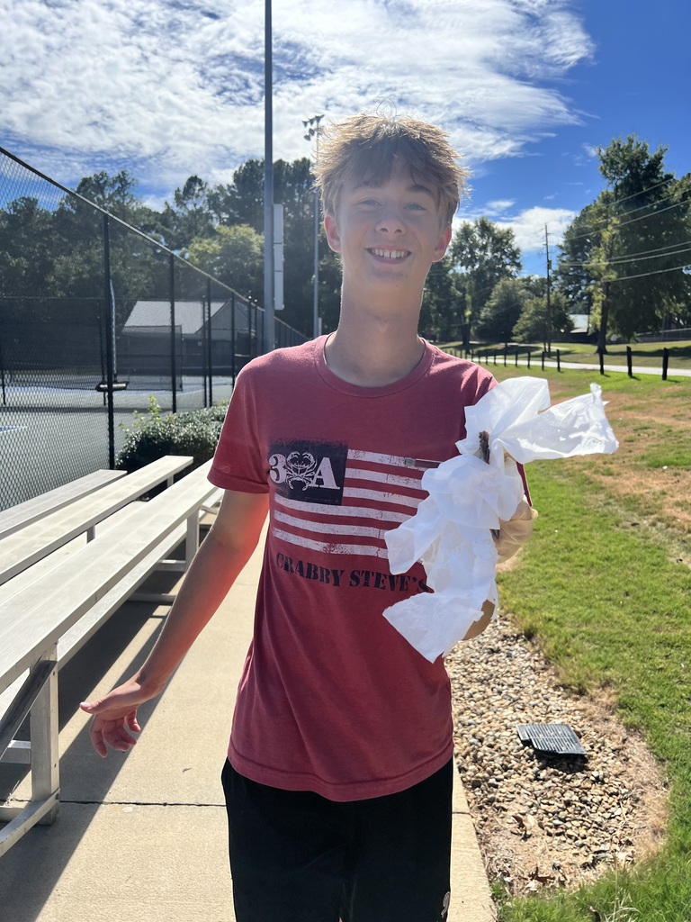 Photos show National Junior Honor Society students working together to clean up the school campus.
