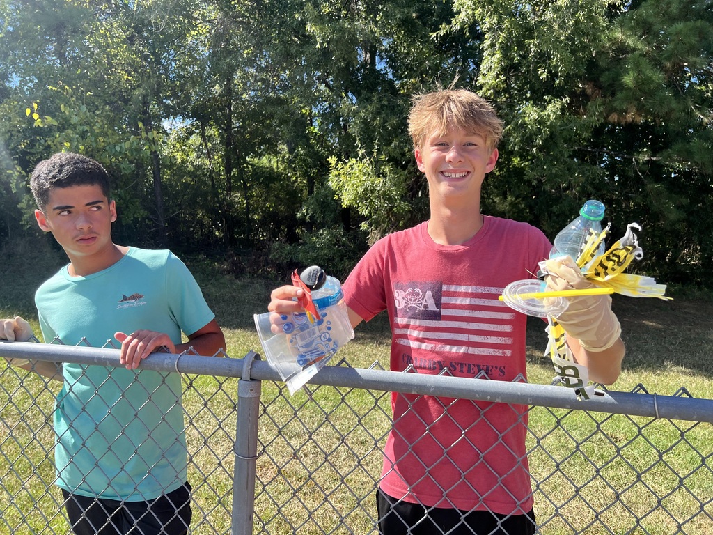 Photos show National Junior Honor Society students working together to clean up the school campus.