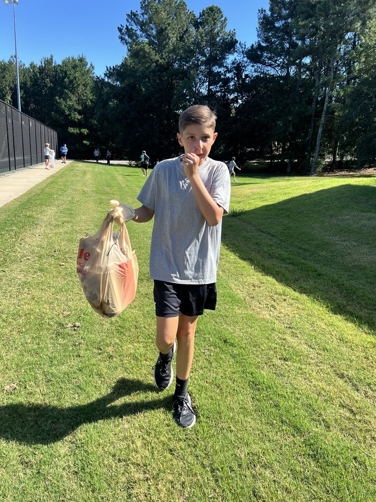 Photos show National Junior Honor Society students working together to clean up the school campus.