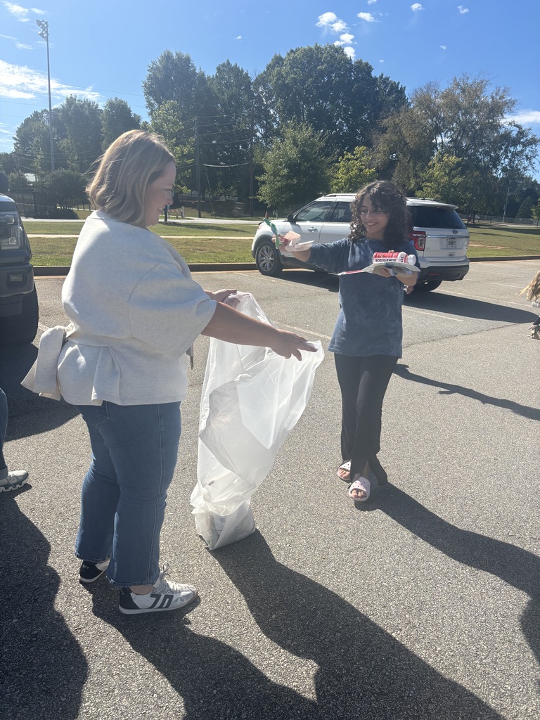 Photos show National Junior Honor Society students working together to clean up the school campus.