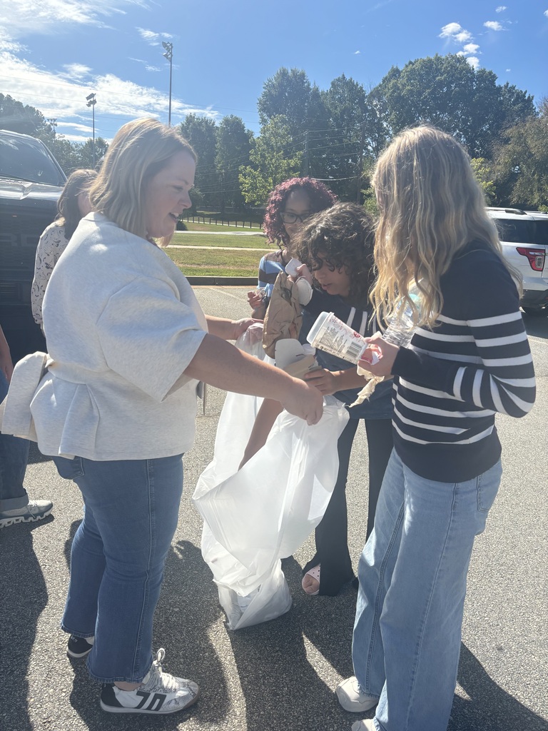 Photos show National Junior Honor Society students working together to clean up the school campus.