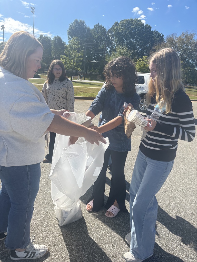Photos show National Junior Honor Society students working together to clean up the school campus.