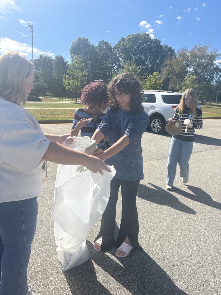 Photos show National Junior Honor Society students working together to clean up the school campus.