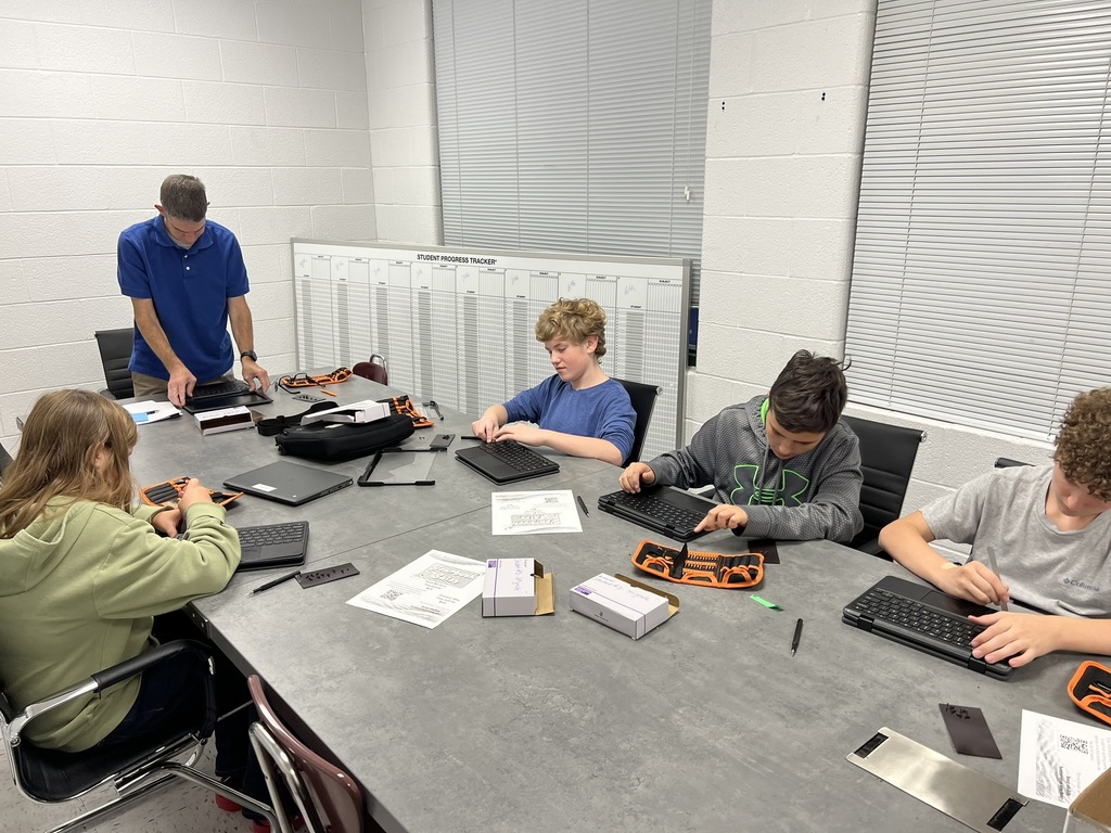 Tech Club - Students taking apart Chromebooks.