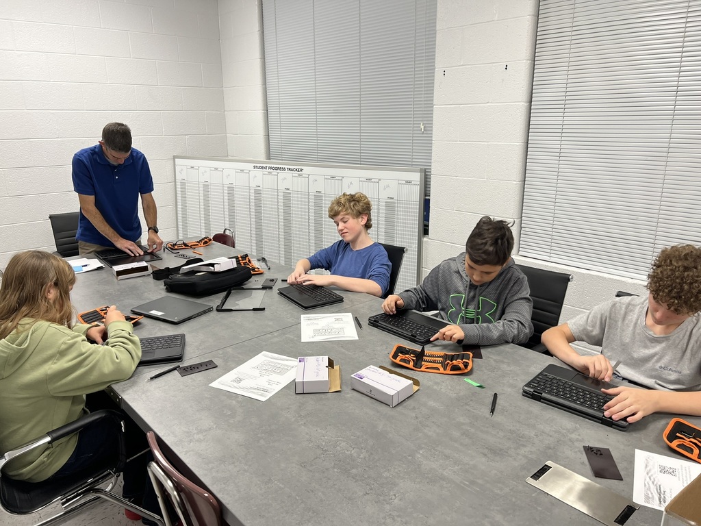 Tech Club - Students taking apart Chromebooks.
