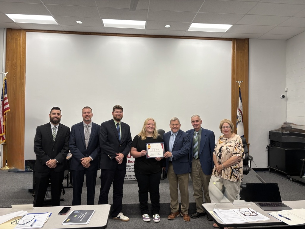 A student with school superintendent and board members.