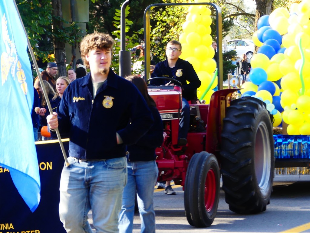 FFA member Chris Stadler holding flag in Apple Butter Parade. 