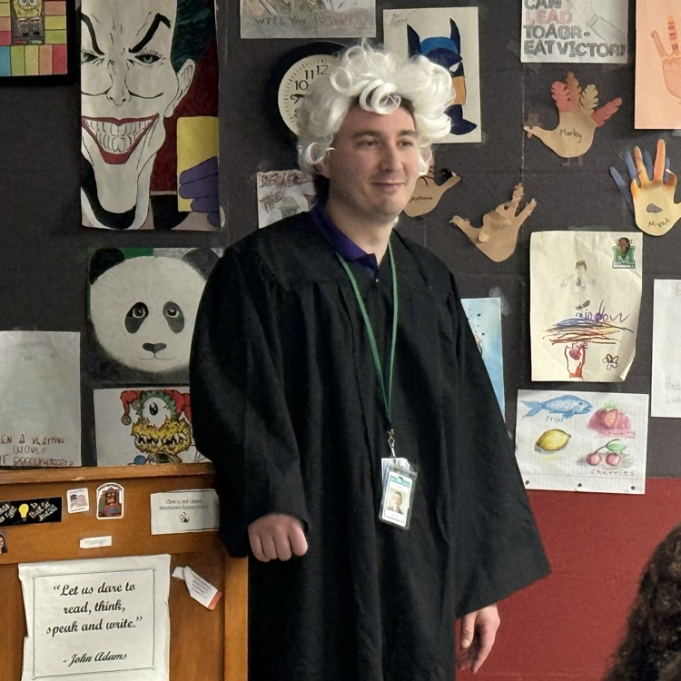Mr. Lacy dressed as a Colonial judge hearing a case regarding the Boston Massacre .