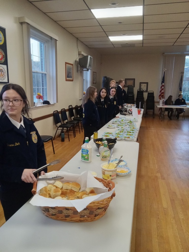 FFA member handing out food a spaghetti dinner. 