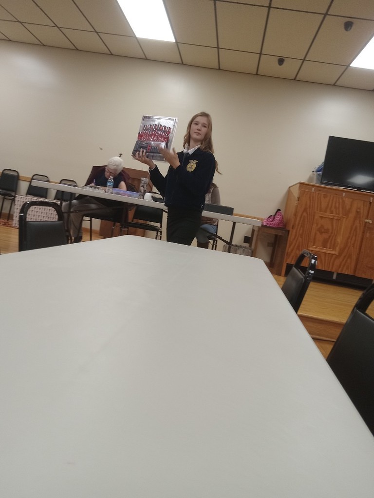 FFA member Ava Michael showing auction items.