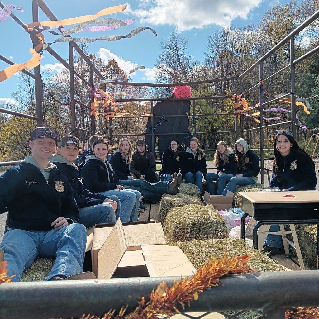 FFA members riding in hay wagon. 