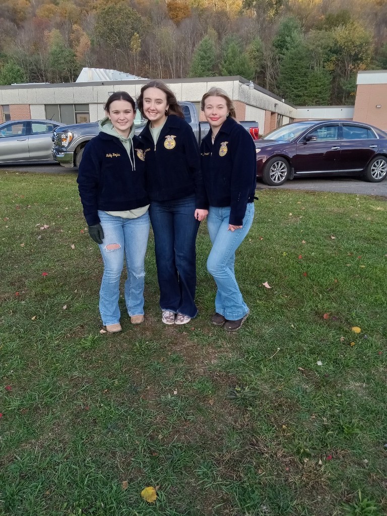 FFA members Janine Hartman, Nora McDonald, and Molly Boyles handing out candy at the pumpkin patch.