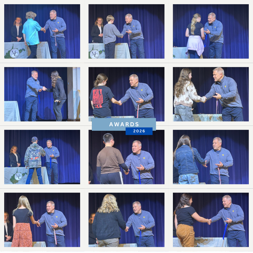 Superintendent presenting awards to science fair winners. 