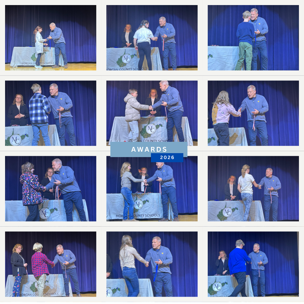 Superintendent presenting awards to science fair winners. 