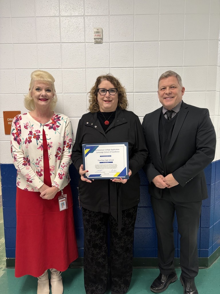 Paw Paw School principal and counselor pose with School of Excellence Award with Superintendent.