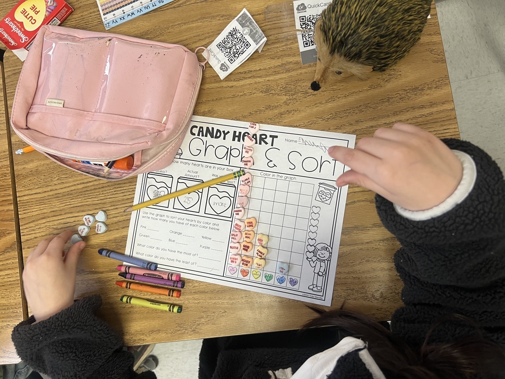 student completing a graphing worksheet using candy hearts