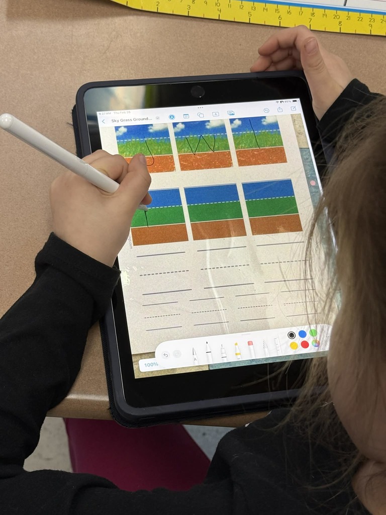 close-up of student using a tablet and pen