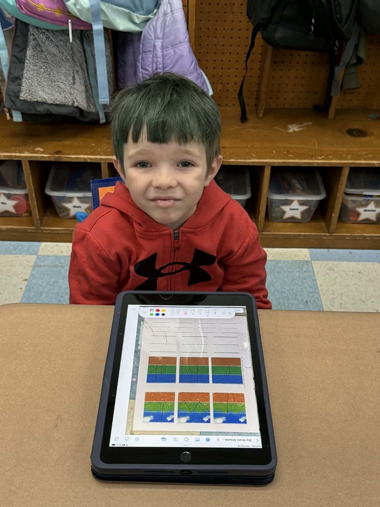 a smiling student with his tablet
