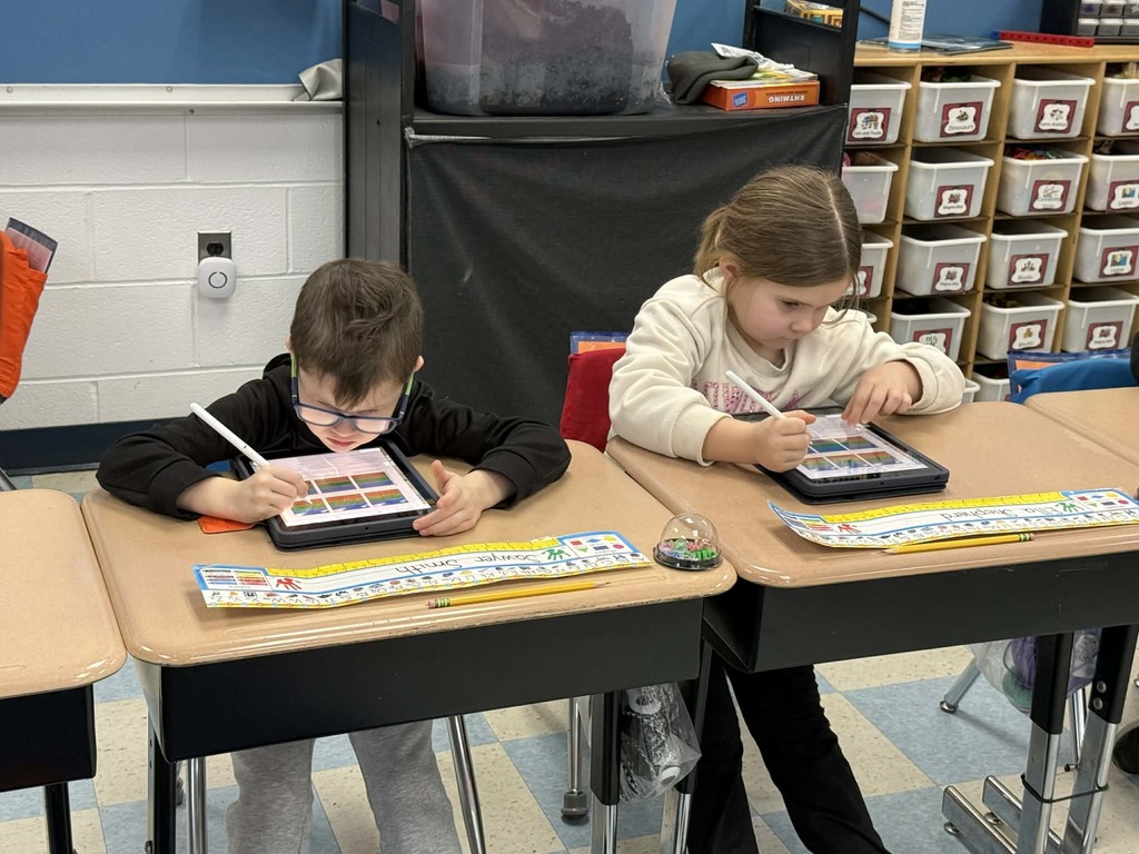 two students working on tablets