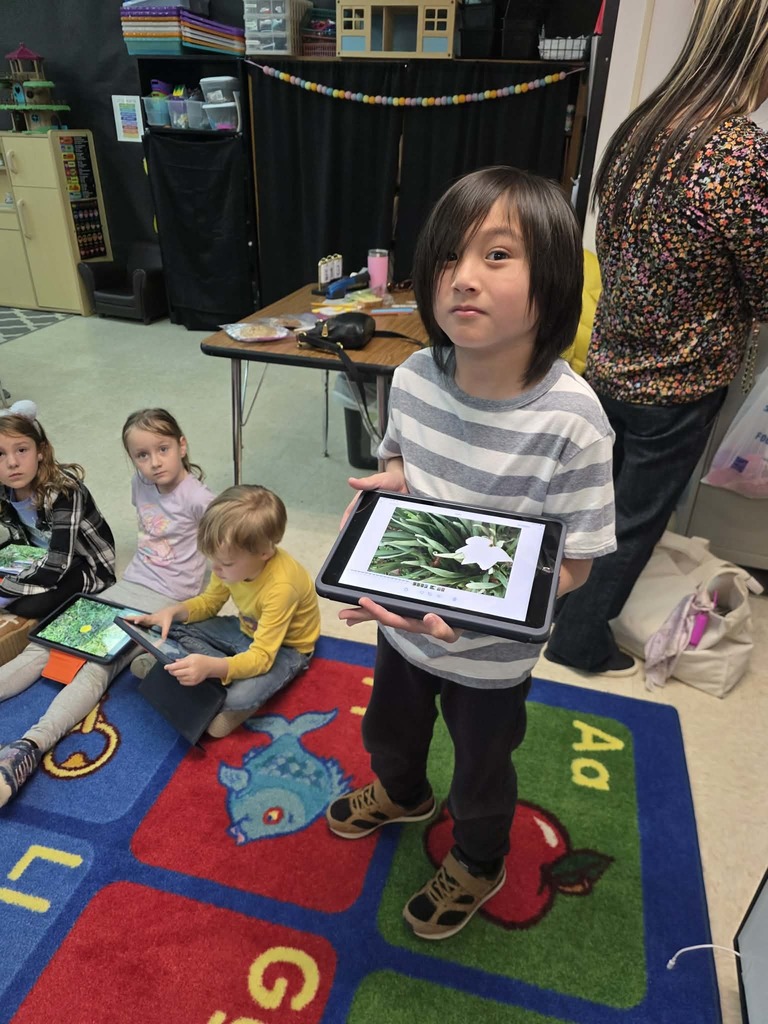 student with an iPad in a classroom