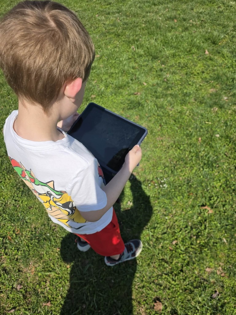 student holding an ipad