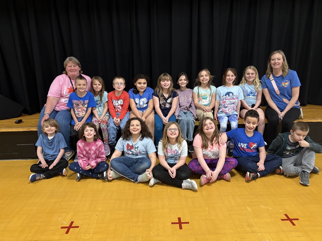 group of students and teachers sitting on a stage