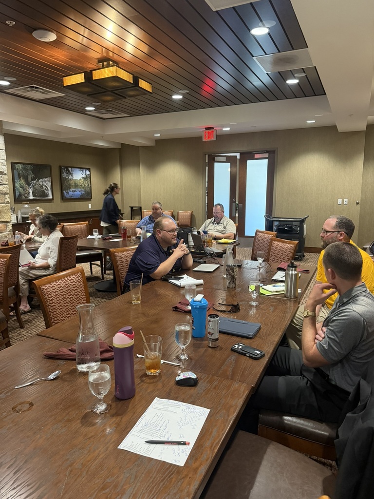 Multiple staff members at a table during admin academy.