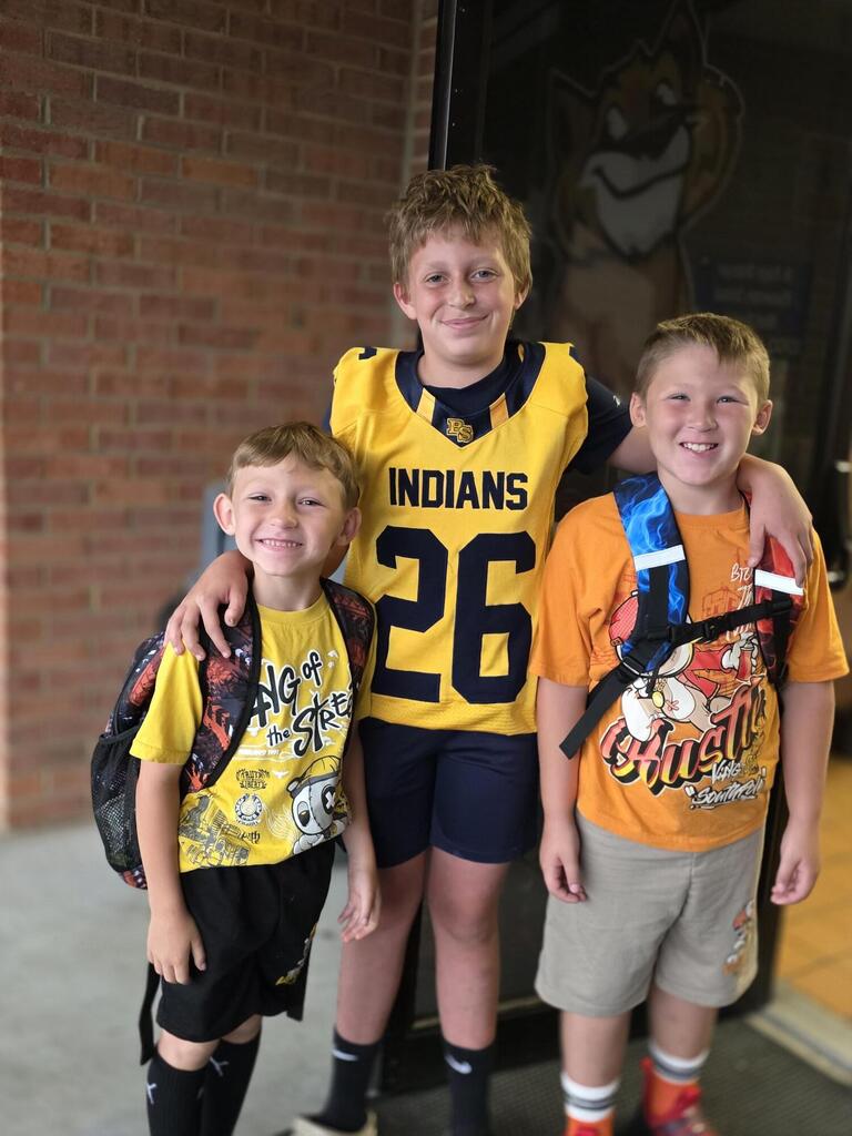 These are pictures of high school students opening car doors and greeting students.