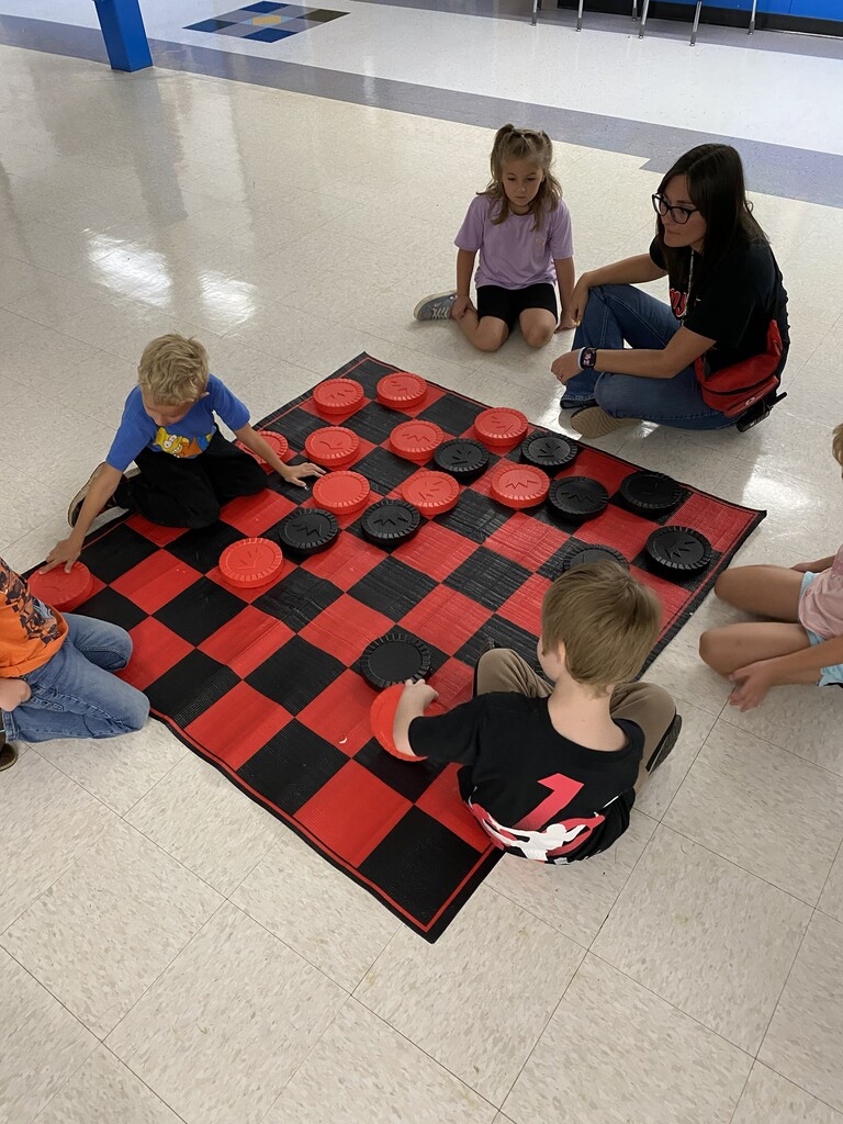 Kids playing a large board game