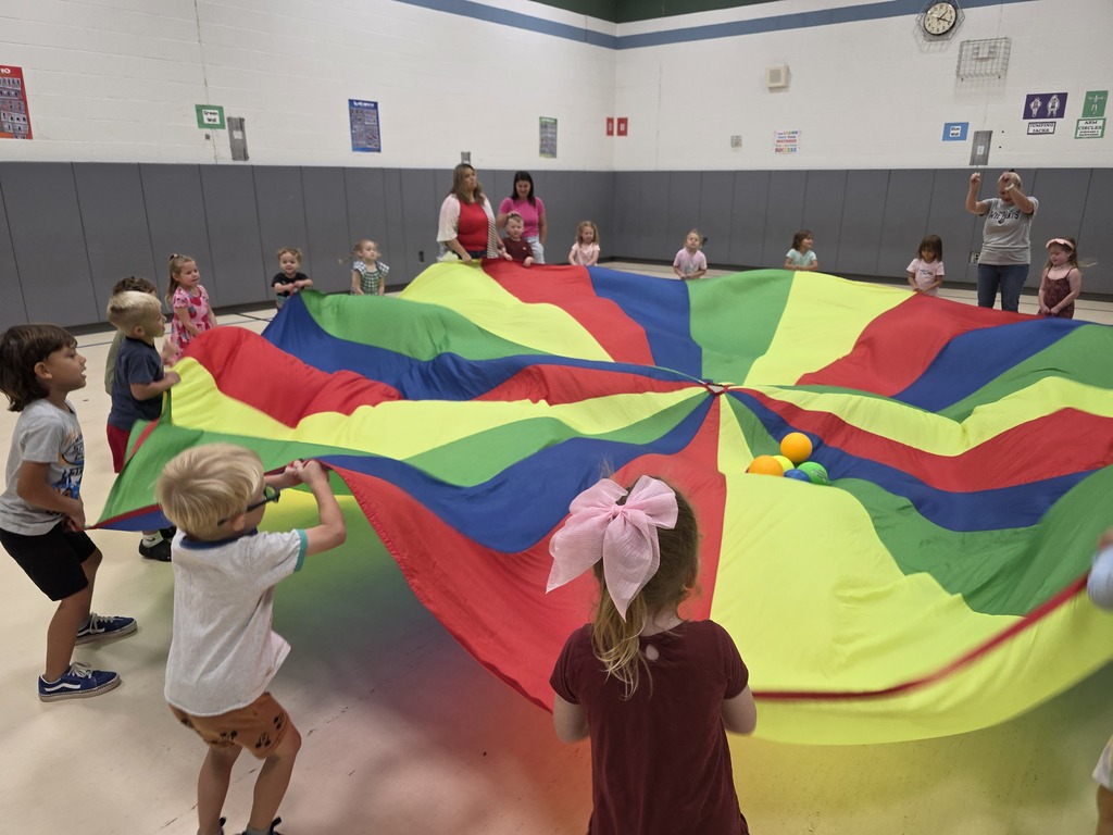 Kids playing with a parachute