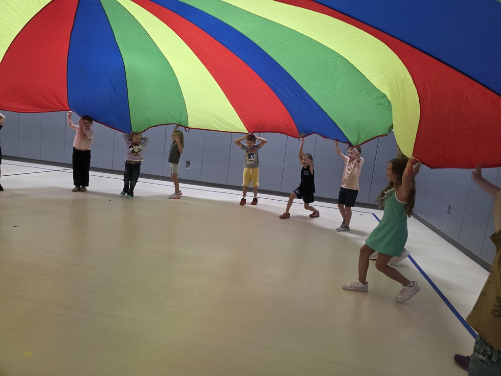 Kids playing with a parachute