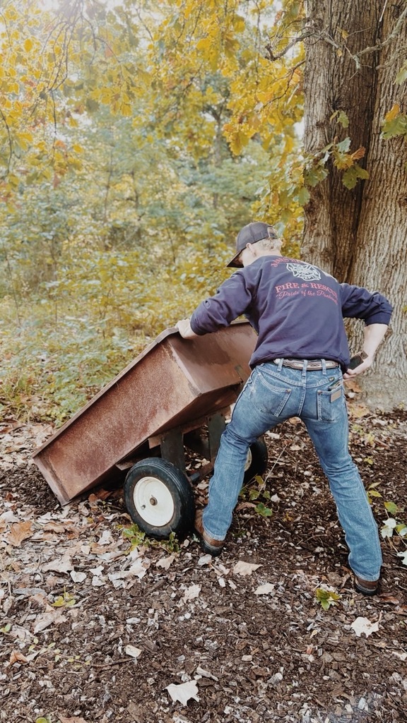FFA member hauls mulch in red trough