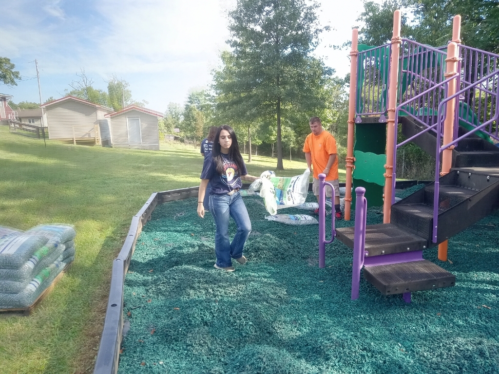FFA Students working to spread mulch at the playground.