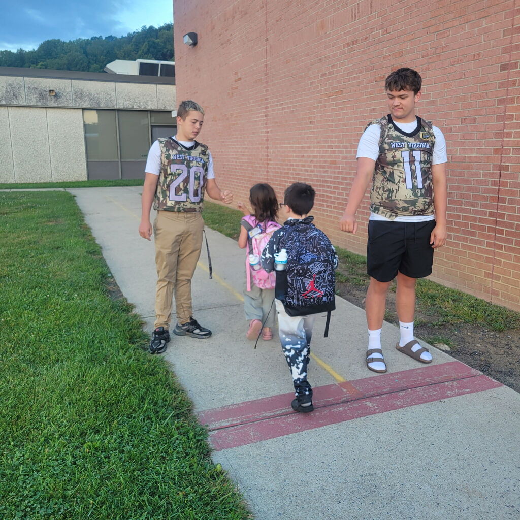 These are pictures of high school students opening car doors and greeting students.