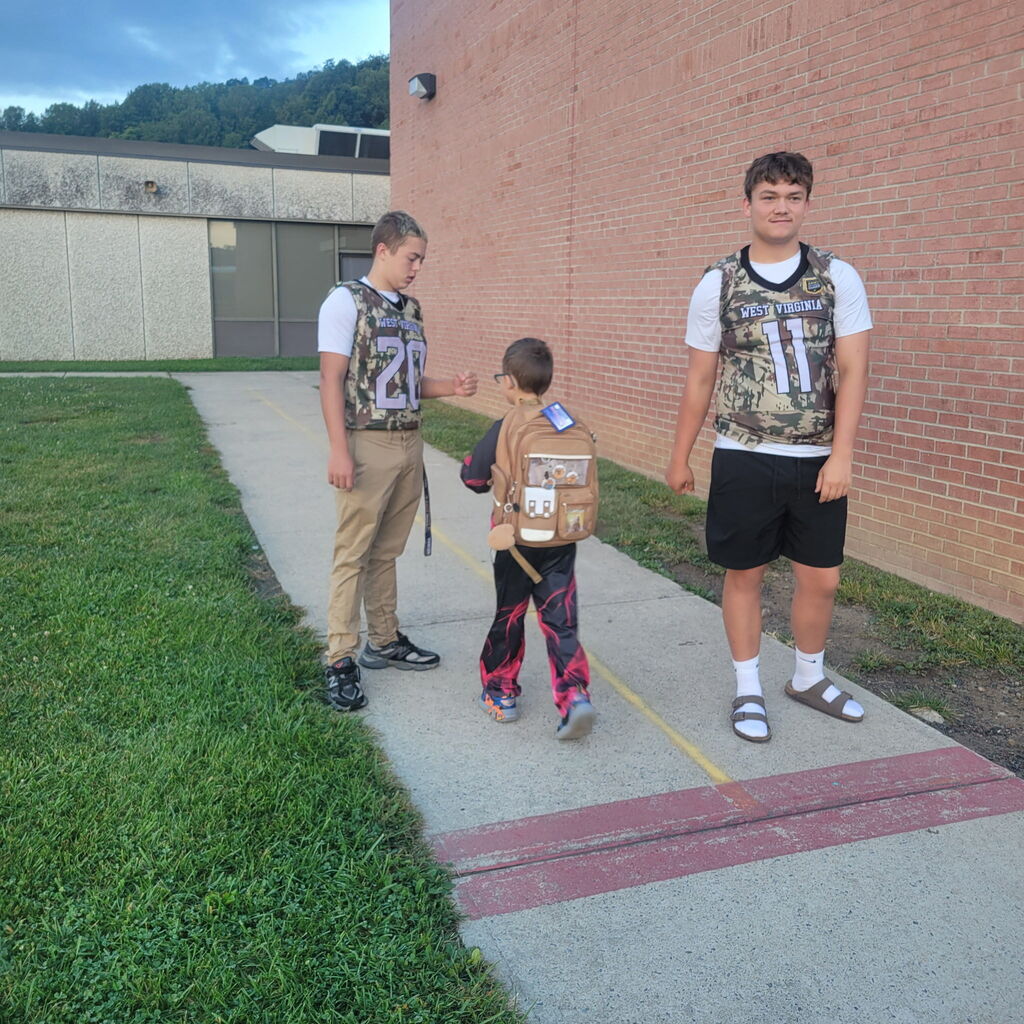 These are pictures of high school students opening car doors and greeting students.