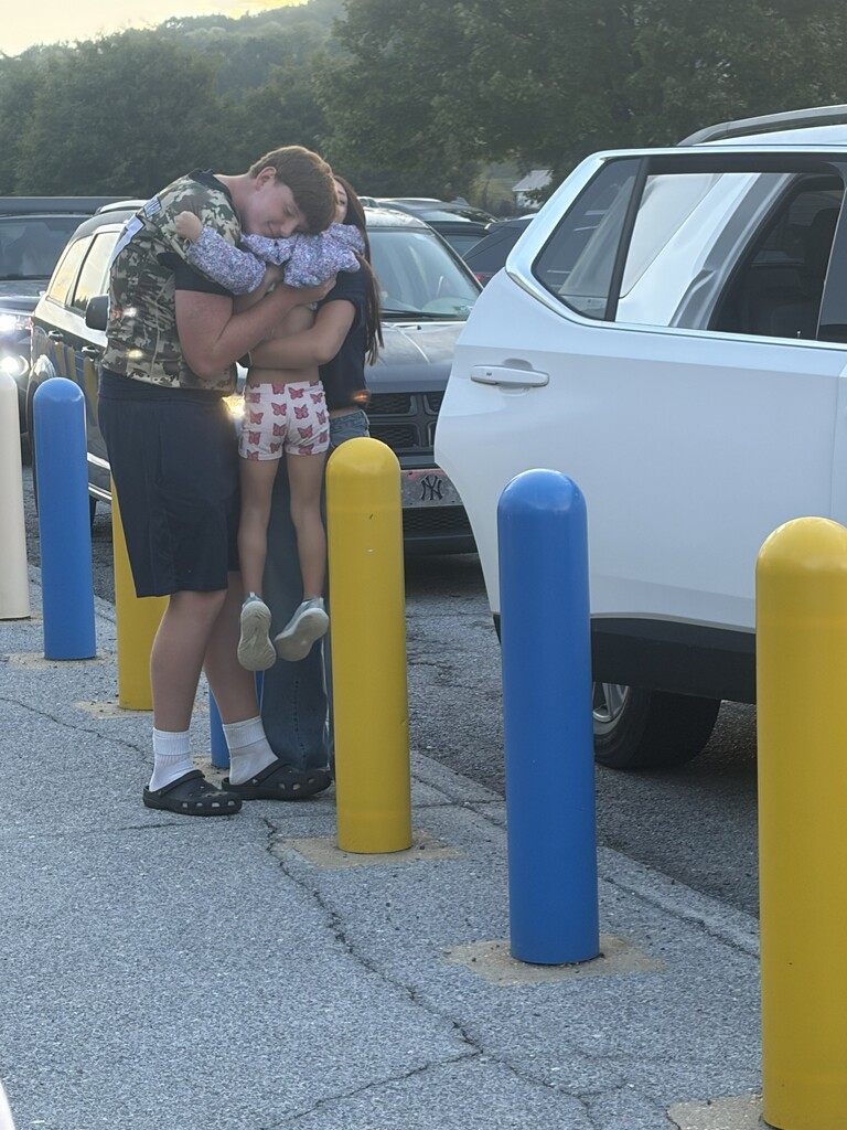 These are pictures of high school students opening car doors and greeting students.
