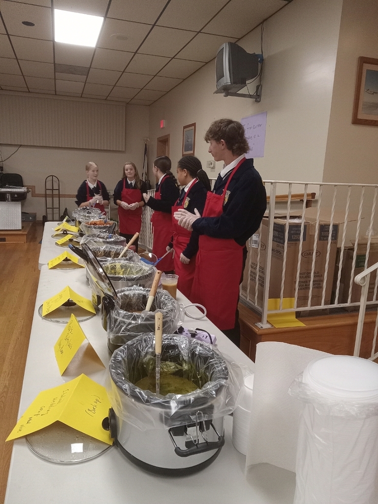 members chat while waiting to serve more guests