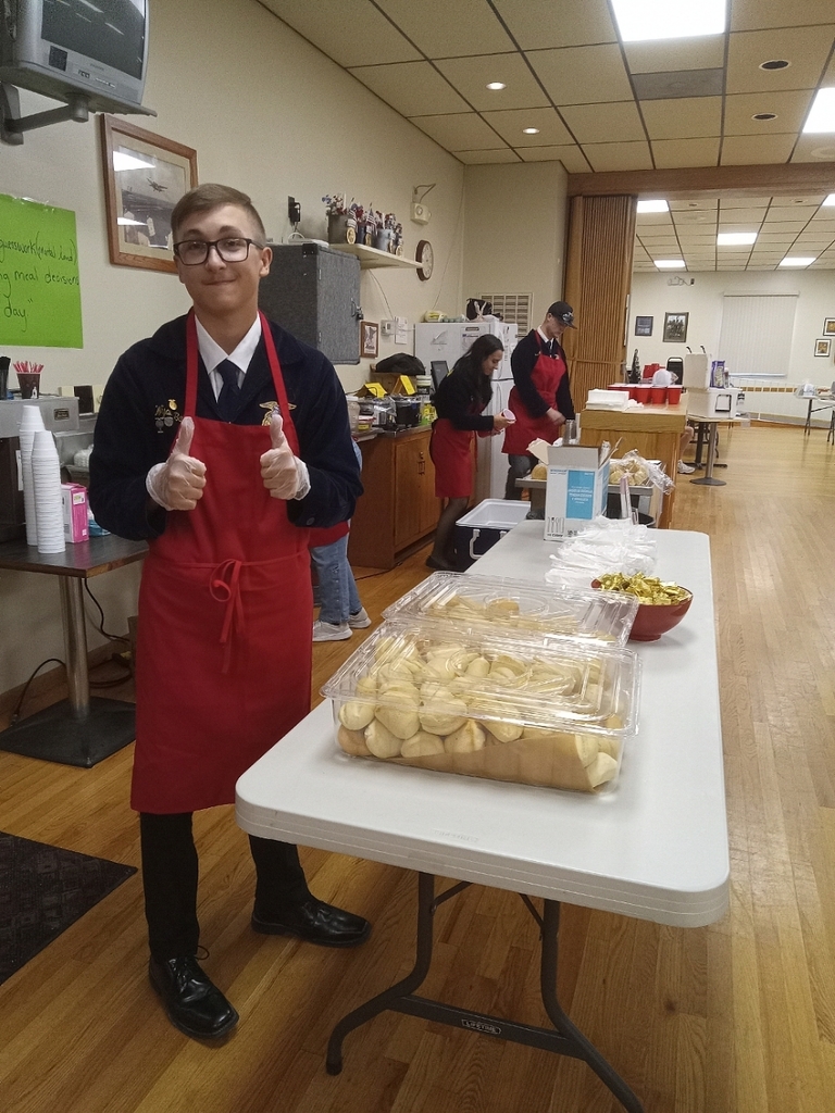 member gives a thumbs up while waiting to serve guests