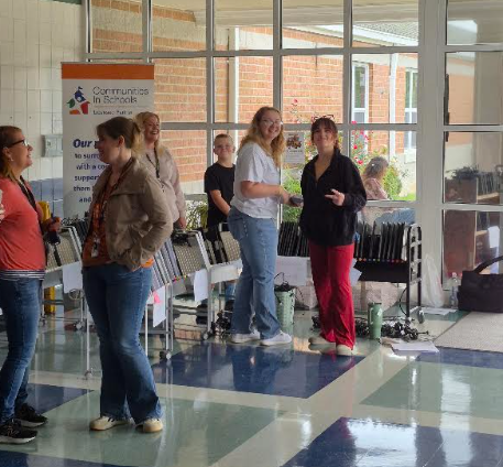 Staff members prepare Chromebooks for distribution to families.